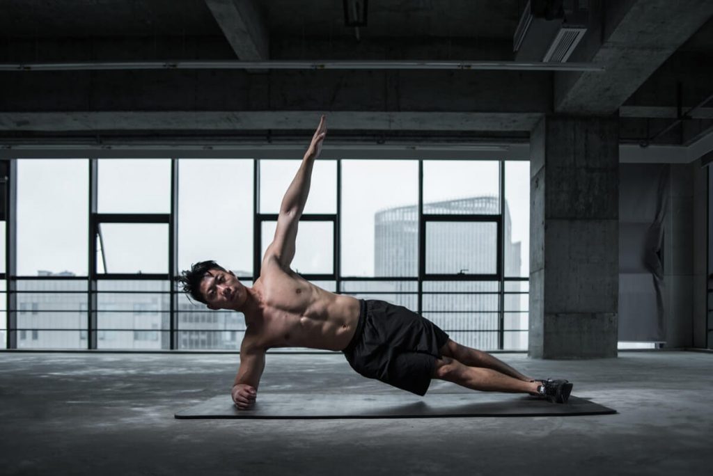 man doing side plank