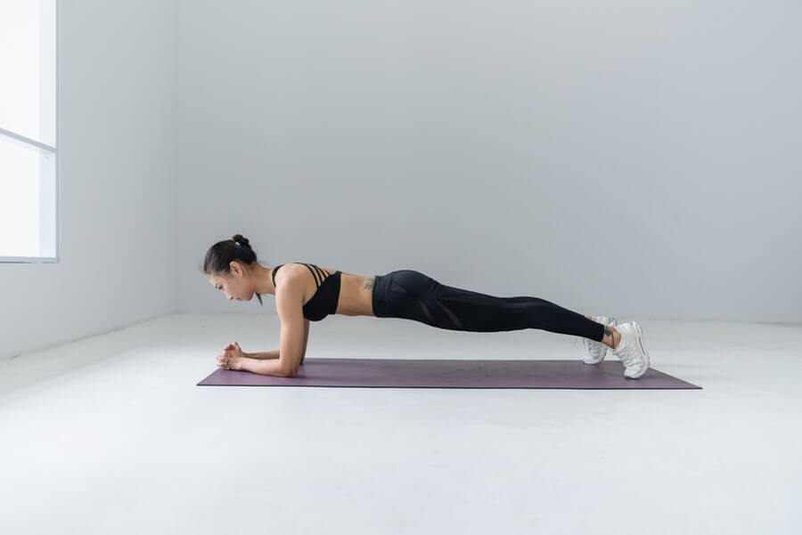 woman doing plank exercise at home