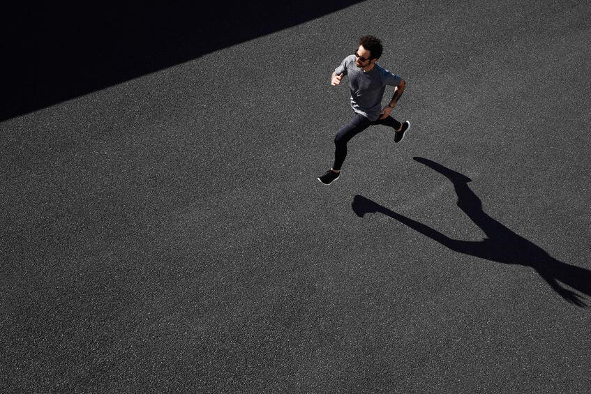 top view of man running on road