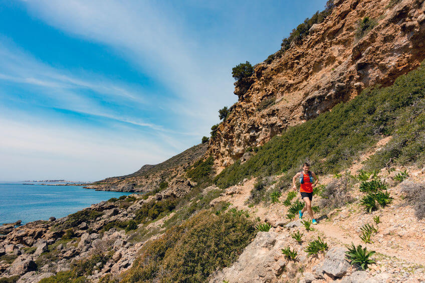 man running in mountains at seaside