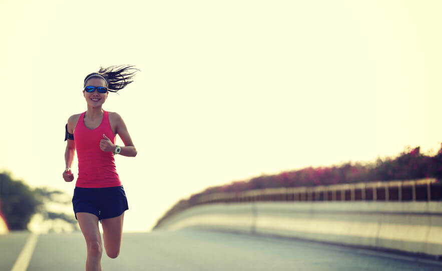 woman runner running on city bridge